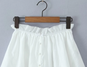 Close-up of white lace trim shorts with button fly and a decorative bow knot