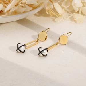 Minimalist gold dangle earrings with white pearls and black geometric star orbit rings