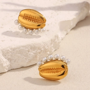 Detailed view of 18K gold plated tooth-shaped earrings with delicate white pearls