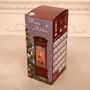 Detail view of the Christmas telephone booth snow globe gift box with rotating feature info