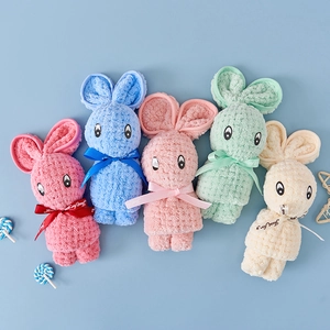 Detail of five colorful coral fleece towels folded into cute rabbit shapes with bows