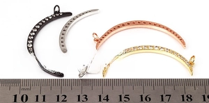 Macro shot of 45mm crescent moon pendants in black, silver, rose gold, and gold with zircons