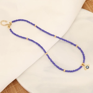 Bohemian purple beaded necklace featuring a golden evil eye pendant and lobster clasp