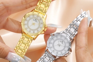 Macro detail of luxury flower pattern dial with crystal inlay in gold and silver