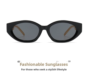 Detail of vintage cat-eye sunglasses featuring black thick frames and dark grey lenses