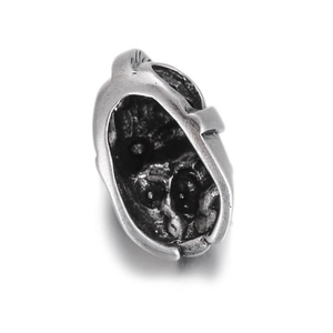 Macro detail of retro silver skull knight charm bead with internal zircon skull engraving