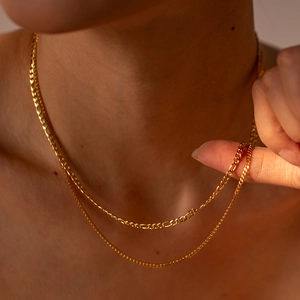 Double-layer 18k gold plated stainless steel Cuban chain necklace worn by a model