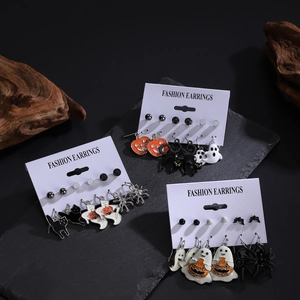 Halloween earring set with pumpkin, black cat, and ghost charms on cardholder