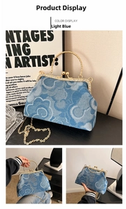 Detail of light blue denim purse with cloud patterns, diamond clasp and gold chain strap