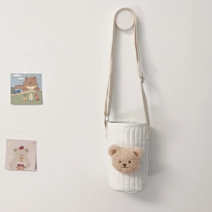 Quilted white water bottle bag featuring a plush bear embroidery and adjustable strap