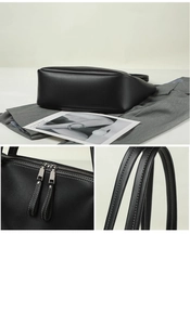 Detail view of black matte tote bag featuring dual metal zippers and white contrast stitching