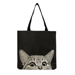 Close-up of black canvas tote bag featuring a realistic cat print with flat webbing handles