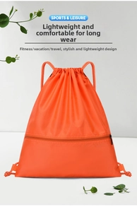 Detail of vibrant orange drawstring sports backpack with front zipper pocket and ripstop fabric