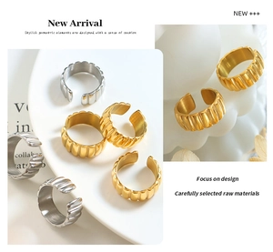 Detailed view of gold and silver textured ribbed rings on a white ceramic plate