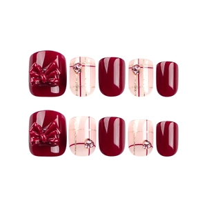 Red and pink press-on nails set with 3D bows, glitter grid patterns, and small rhinestones
