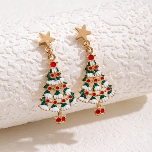 Close-up of alloy Christmas tree drop earrings with green and red enamel and gold stars