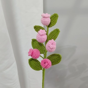 Handmade pink crochet flower branch with green leaves for home decor and gifts