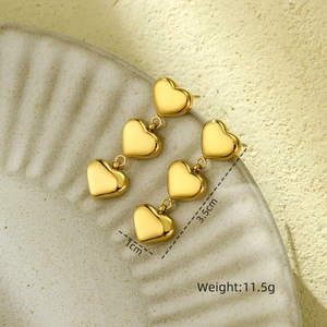 Detailed view of triple heart gold earrings with 3.5cm length and 11.5g weight specs