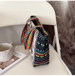 Detailed side view of ethnic embroidered tote bag featuring colorful woven patterns