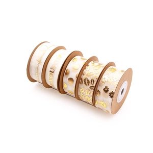 Close-up of gold-stamped organza ribbons with heart and letter patterns for gift wrapping
