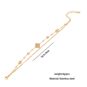 Detail view of double-layer gold stainless steel bracelet with crystal flower charms