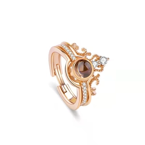 Detail of rose gold crown ring featuring a projection stone lens and micro-set crystals