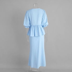 Rear view of light blue two-piece set with puff sleeve top and straight long skirt