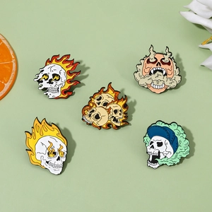 Set of five punk style skull enamel pins with colorful demonic and fire designs