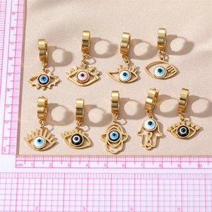 Golden stainless steel evil eye and Hamsa hand drop earrings displayed with measurement