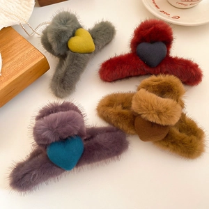 Detailed view of plush heart claw clips in various colors with soft faux fur texture