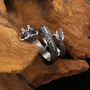 Macro detail of vintage silver steel dragon ring with intricate scale engraving on wood