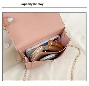 Internal capacity of pink PU leather crossbody bag with chain strap and gold hardware