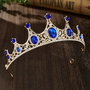 Detailed close-up of golden vintage crown with blue gems and intricate crystal carvings