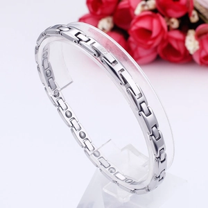 Detailed close-up of a silver stainless steel magnetic therapy bracelet with germanium stones