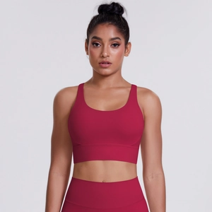 Detail of high-waist yoga leggings and dark red sports bra in seamless elastic fabric