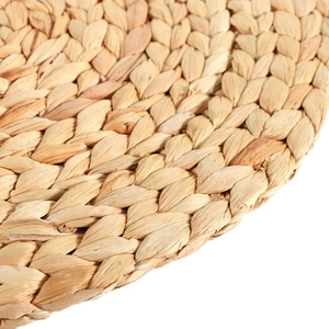 Handwoven natural water hyacinth round placemat featuring intricate textured braided patterns