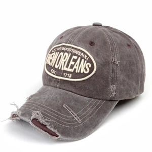 Close-up of distressed baseball cap with vintage embroidery and worn-out details