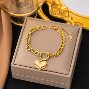 18k gold plated stainless steel layered chain bracelet featuring a polished heart pendant