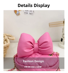 Close-up of pink quilted mini bag with oversized bow and golden metal chain strap