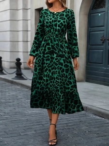 Close-up of green leopard print dress featuring lantern sleeves and ruffled hem detail