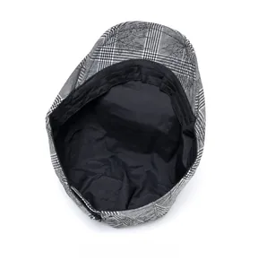 Detailed internal view of plaid flat cap showing black fabric lining and reinforced stitching