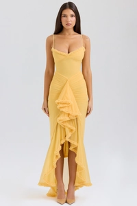 Detail of yellow camisole dress with delicate ruffles and asymmetric fishtail hemline