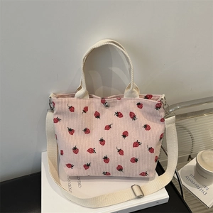 Pink corduroy shoulder bag with strawberry embroidery and adjustable shoulder strap