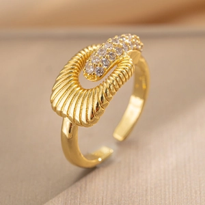 Adjustable gold plated wave ring with sparkling zircon stones in a macro 45-degree view