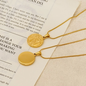 Vintage gold coin pendant necklace with zodiac sun relief on a sleek snake chain