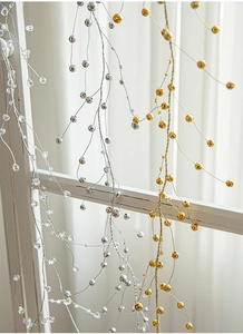 Close-up of gold and silver faceted acrylic bead garland on wire for holiday decor
