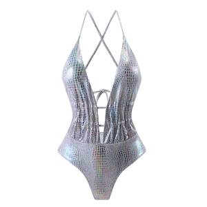 Detailed macro view of laser holographic snakeskin texture on metallic one-piece swimwear