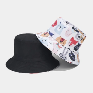 Detail showing reversible bucket hat with cute cartoon animal print and plain black side