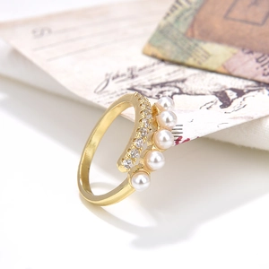 Elegant adjustable gold ring with baroque pearls and zircon accents on vintage paper