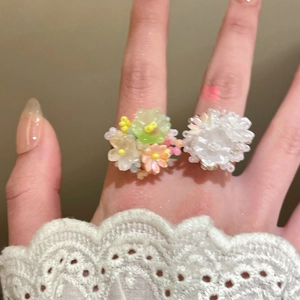 Detail of handmade beaded flower rings with colorful beads for a fresh summer beach style